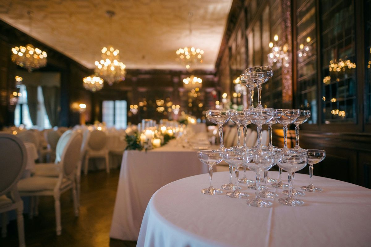 Champagne coupe tower on a white linen table in an event room